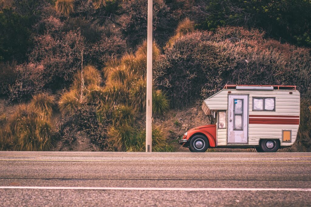 RV and camper trailer on a summer highway — Memorial Day weekend towing tips for a safe holiday trip
