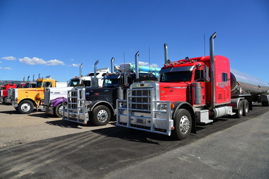 Semi truck driving on an open highway with clear skies