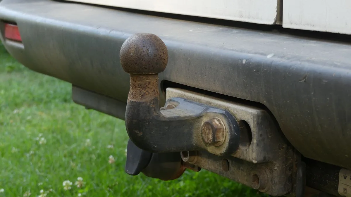 Detailed close-up of a trailer hitch as part of a pre-trip towing safety checklist inspection